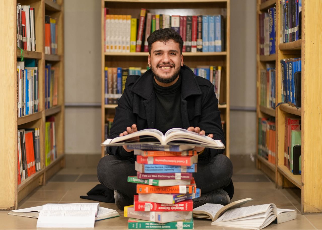 Osamah Hussein in library studying and learning